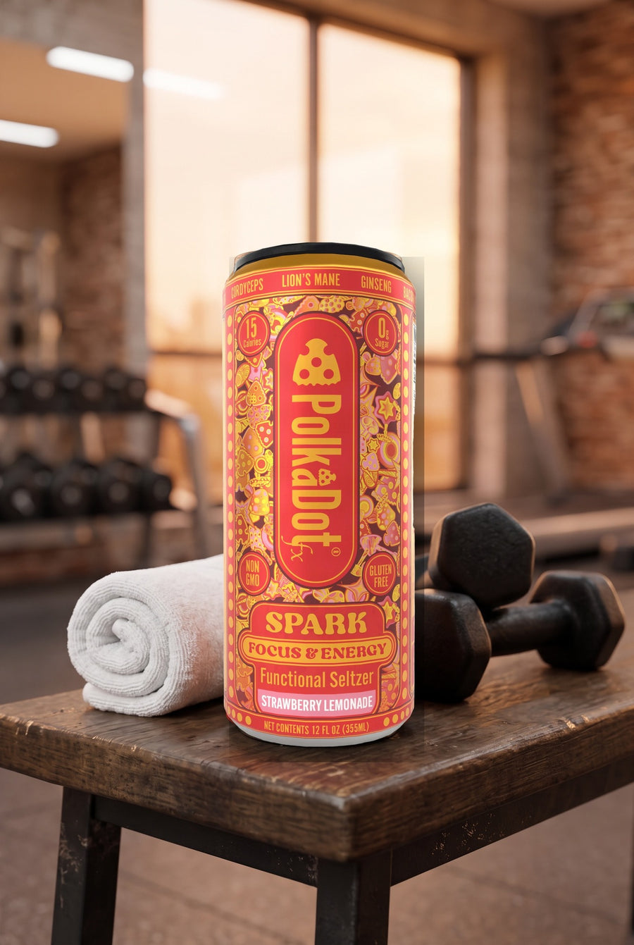 PolkaDotFx Spark functional seltzer can on a gym bench beside a towel and dumbbells